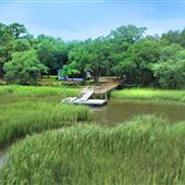 15 Acres Undeveloped Marsh Front & Maritime Forest Waterfront Featuring Two Log Cabins, Remodeled Home & Tree Canopied Roads