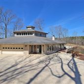 Custom built, all glass, hexagon home on 80 acres!