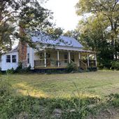Farmhouse built 1899 renovated 1950 w exterior barns and buildings plus 30’ creek