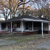 Timeworn Home with adjacent properties on dead end street