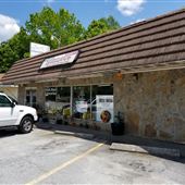 Old shopping strip center and deli market in Tyrone