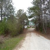 Long Dirt Driveway Leads to 1900s Farmhouse