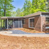 Mid century modern cabin on a pond