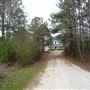 Long Dirt Driveway Leads to 1900s Farmhouse